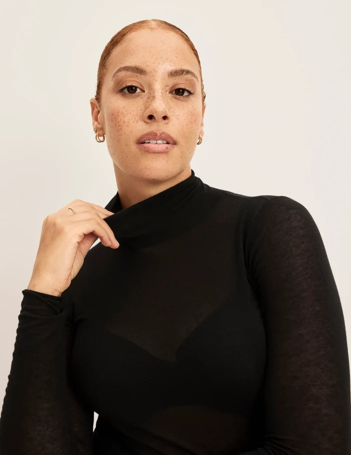 | Front view of model wearing the Cashmere Mist Turtleneck highlighting the neckline and fit | Black