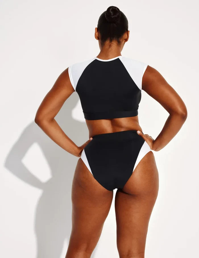 Amber has 44” hips and wears a Knix size L | Back view of model wearing the High Rise Bikini Swim Bottom highlighting the coverage and fit | Black/White