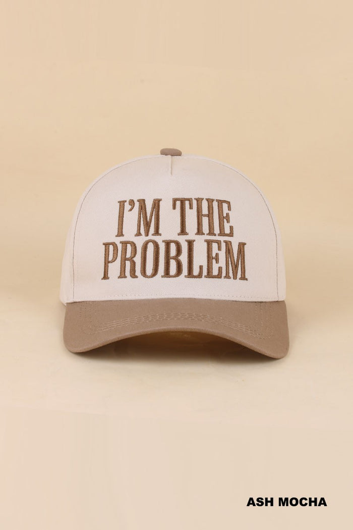 light brown bill baseball style cap that says "I'm the problem"