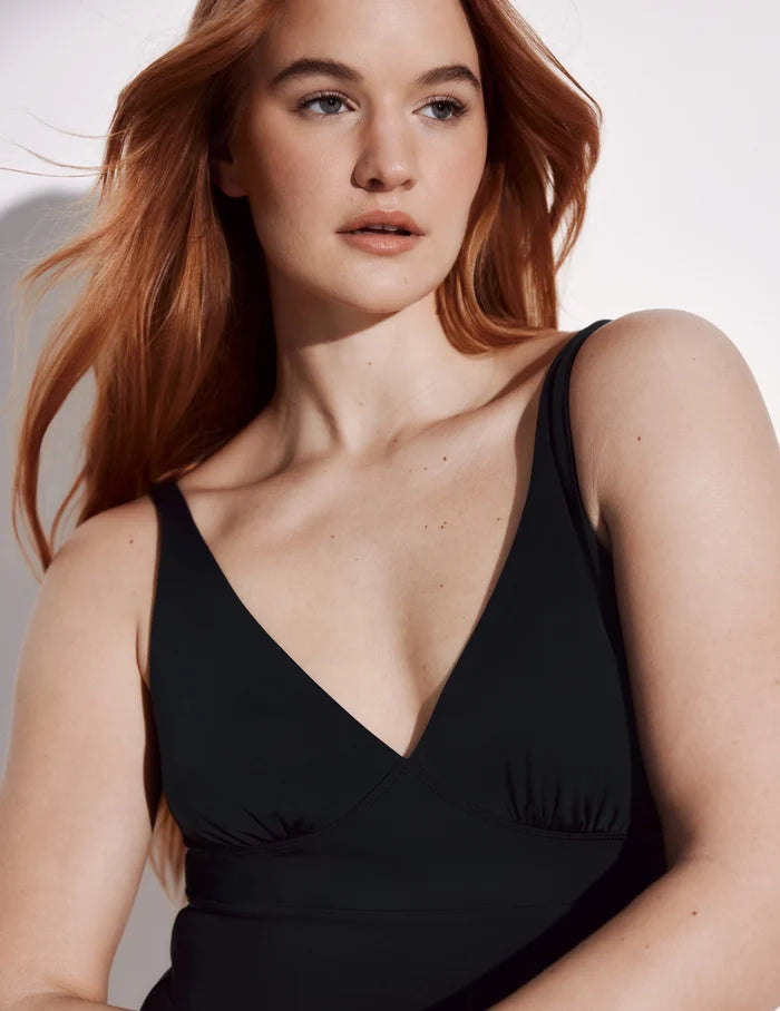 | Front view of model wearing the Leakproof Deep V One Piece Swimsuit highlighting the neckline, coverage and fit | Black