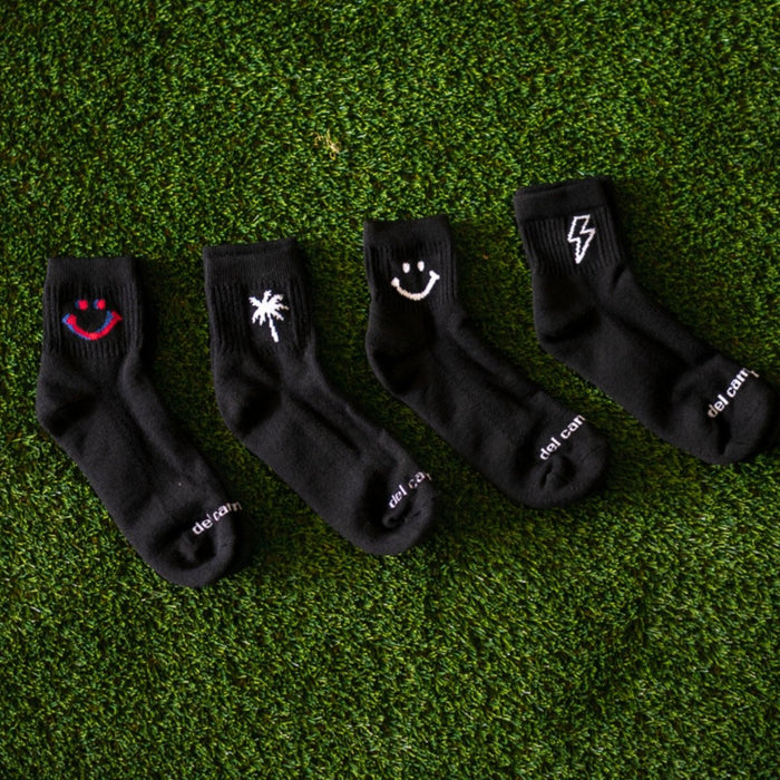Del Campo Night Mode Pack golf socks featuring all four Night Mode designs: bolt, palm, smiley, and 1776