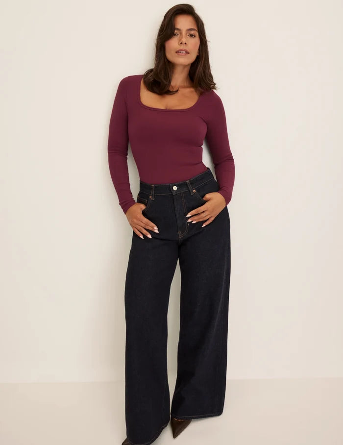 Maya is a 34DDD wearing KNIX M | Front view of model wearing the SculptRib™ Cotton Long Sleeve Top highlighting the neckline, fabric and hugging fit | Dark Cherry