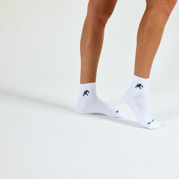 Woman wearing Del Campo Wake Forest Walking Deacon golf socks, studio shot, no shoes
