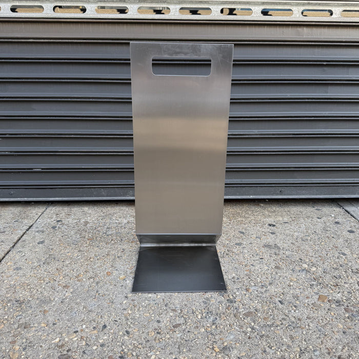Rear view of a stainless steel floor sign with a handle cutout.