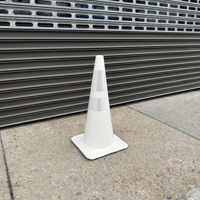 Side view of a white traffic cone with a square base.