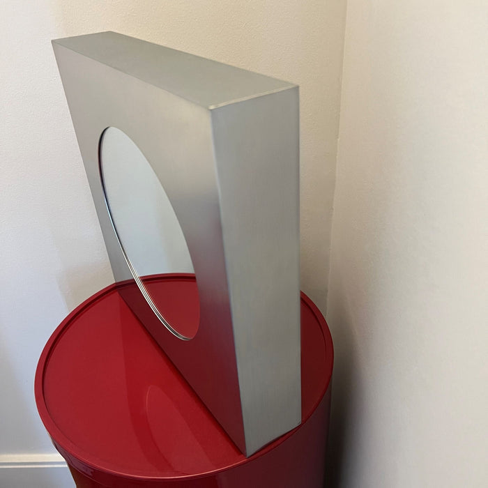 Side view of a square Forma mirror showing the depth of its stainless steel frame.