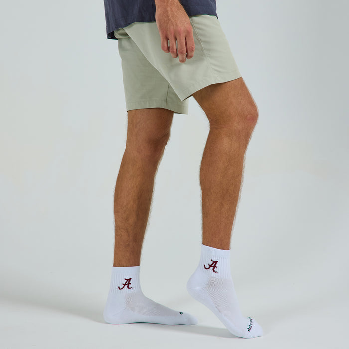 Man wearing Del Campo Alabama Crimson Tide golf socks, studio shot, no shoes