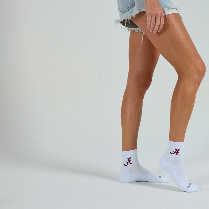 Woman wearing Del Campo Alabama Crimson Tide golf socks, studio shot, no shoes
