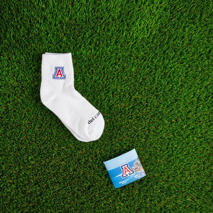 Flat lay of Del Campo Arizona Wildcats golf socks with game-day props