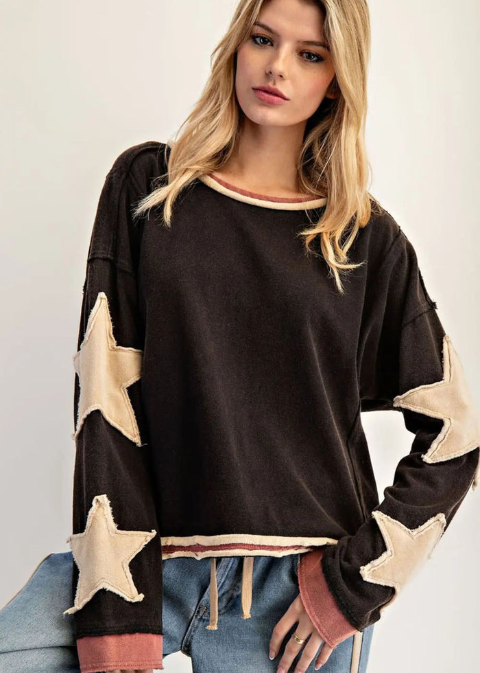 Long sleeved ash black base, with cream color star accents on sleeves