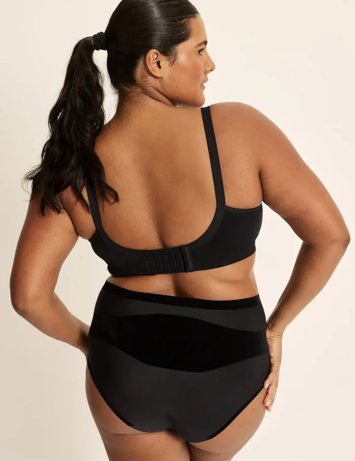 Adiya is a 36C and wearing KNIX L | Back view of model wearing the BlissFit™ Nursing/Pumping Bra, highlighting the neckline, nursing clip strap design, and smooth silhouette | Black
