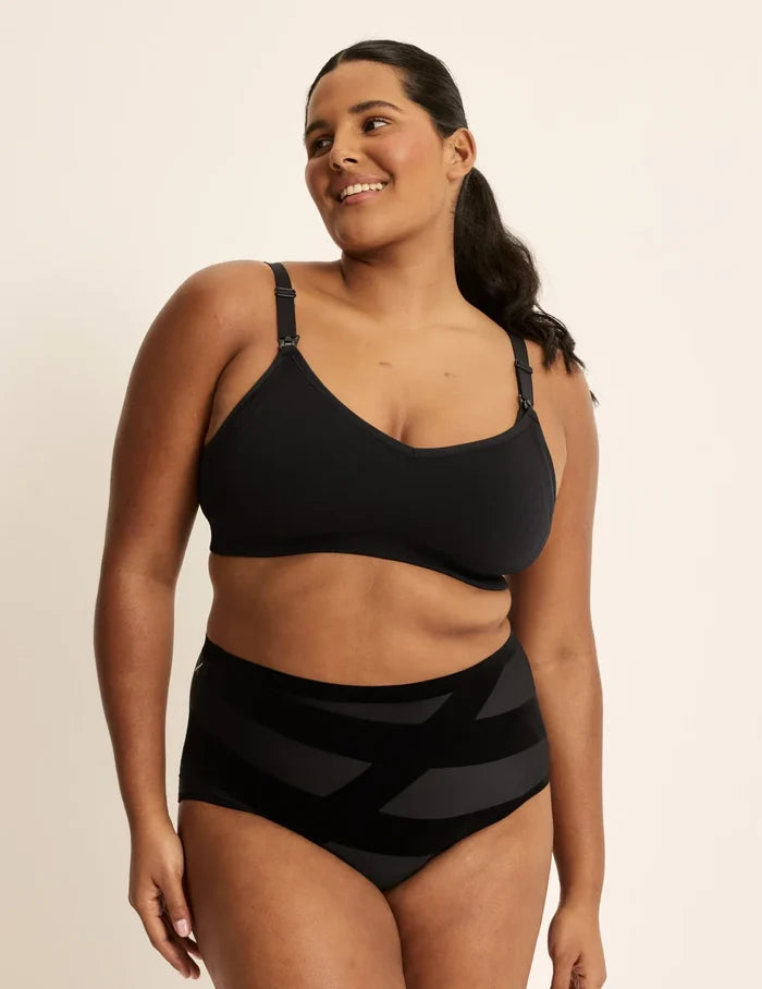 Adiya is a 36C and wearing KNIX L | Full-body view of model wearing the BlissFit™ Nursing/Pumping Bra, highlighting the neckline, nursing clip strap design, and smooth silhouette | Black