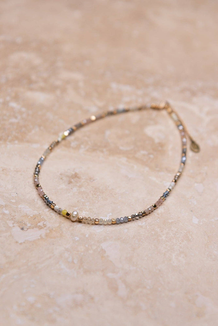 Adjustable, multi color beaded choker with pearl bead in center. 16" long