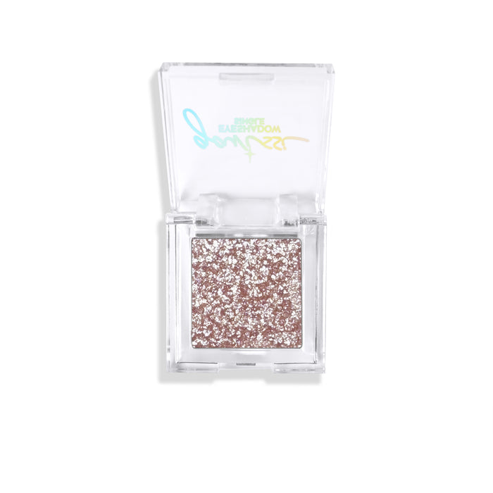 Shimmery eyeshadow in a clear compact with brand logo on a white background.