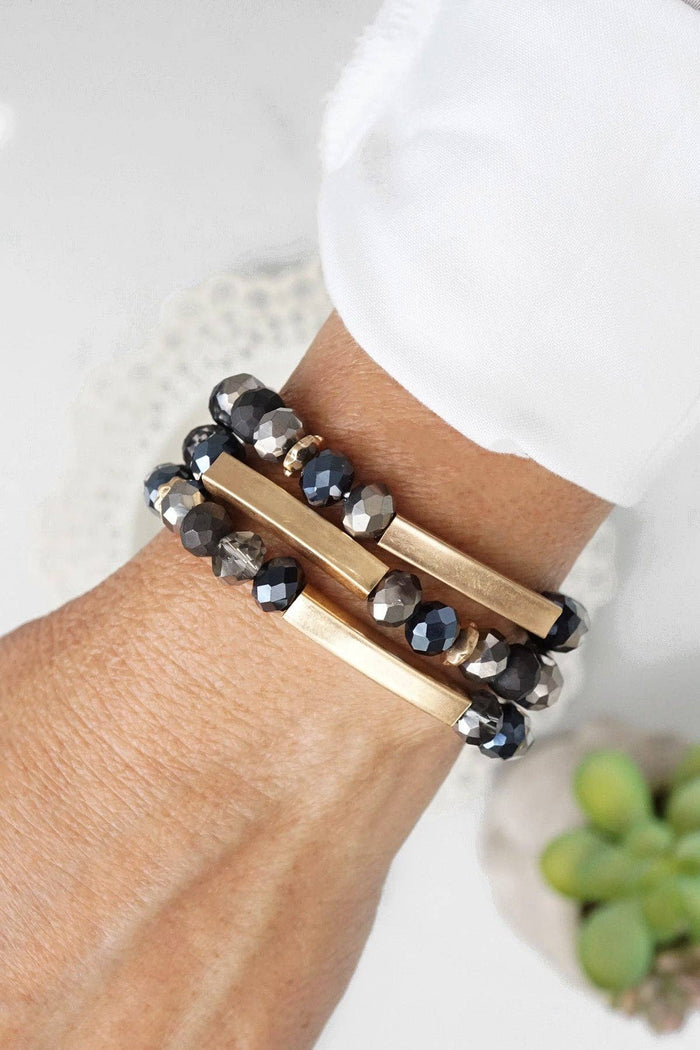 Beaded bracelets set in Black Glass Beads and Gold tubes Beaded bracelets set of 3 stretchy bracelets: Black and Grey Hematite faceted glass beads. Worn Gold spacer beads and square tubes Stretchy - One size fits most Perfect day to night accessory, goes with everything.