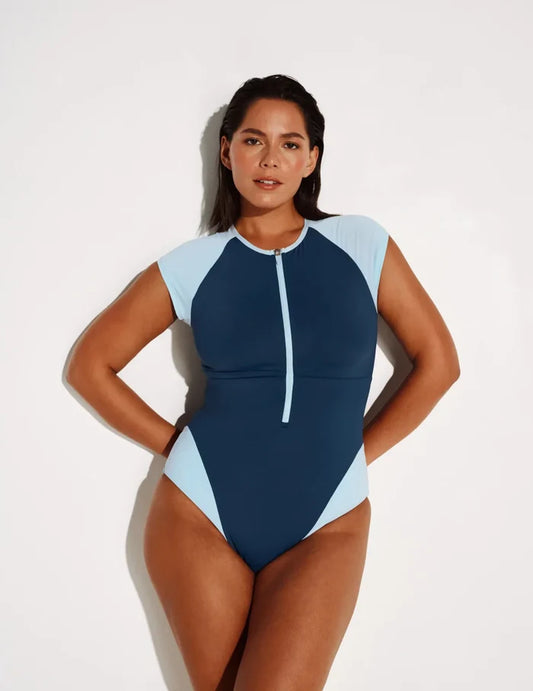 Maya is 5’7”, a 34DDD, has 43” hips and wears a Knix size L | Front view of model wearing the Cap-Sleeve One Piece Swimsuit highlighting the neckline, coverage and fit | Horizon/Blue Ice