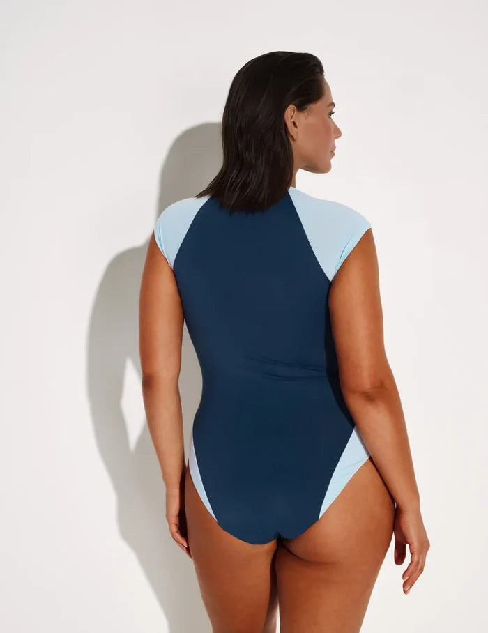 Maya is 5’7”, a 34DDD, has 43” hips and wears a Knix size L | Back view of model wearing the Cap-Sleeve One Piece Swimsuit highlighting the neckline, coverage and fit | Horizon/Blue Ice