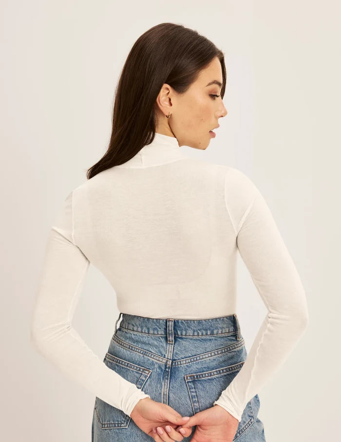| Back view of model wearing the Cashmere Mist Turtleneck highlighting the neckline and fit | Ivory