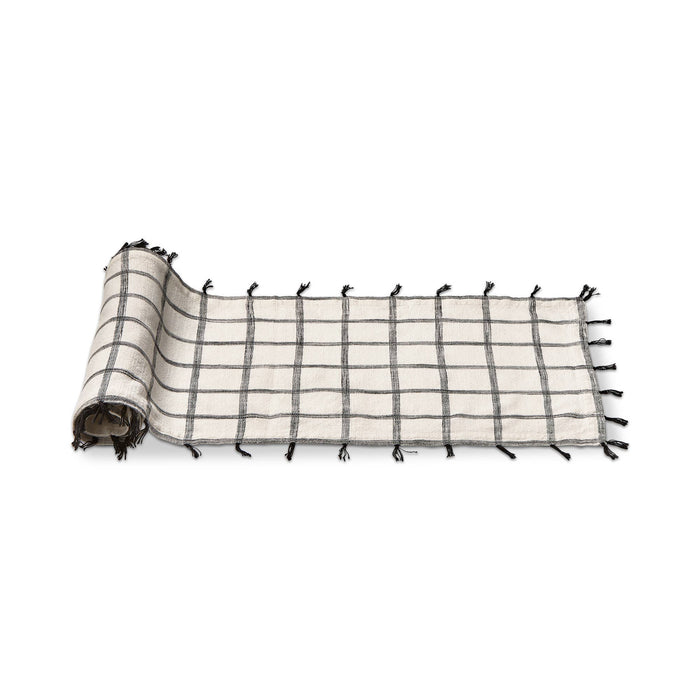 This white and black 100% cotton runner is slub woven with self tassles in black