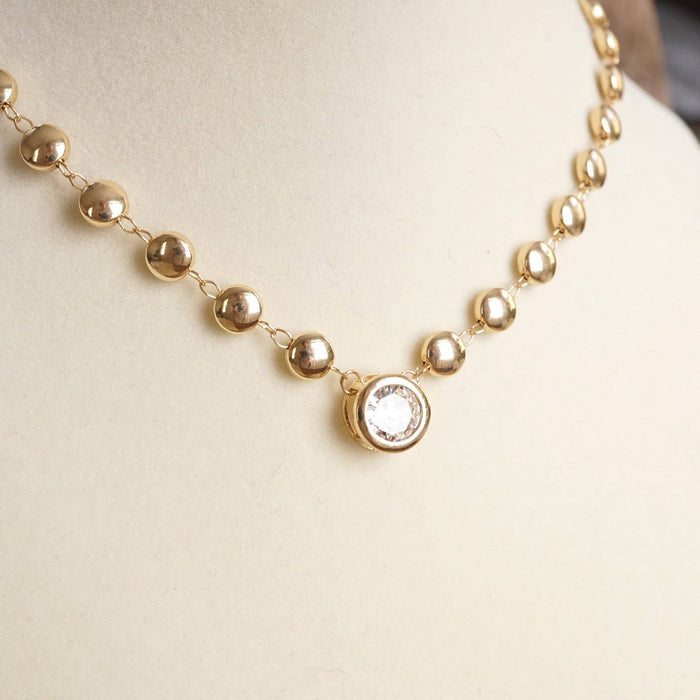 Clear Crystal Bezel Pendant Dot Chain Necklace combines timeless elegance with modern flair. Available in gold or silver tone, its delicate dot chain and clear crystal bezel pendant make it the perfect piece to complement any outfit. 
In silver and gold color