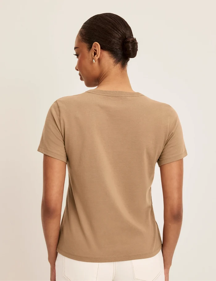| Back view of model wearing the Cotton Relaxed T-Shirt highlighting the coverage and fit | Cashew
