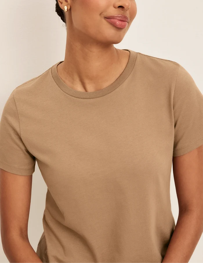 | Front view of model wearing the Cotton Relaxed T-Shirt highlighting the coverage and fit | Cashew