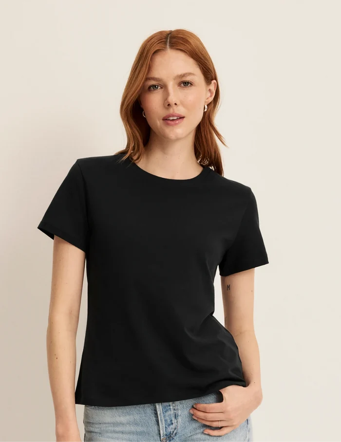 | Front view of model wearing the Cotton Relaxed T-Shirt highlighting the coverage and fit | Black