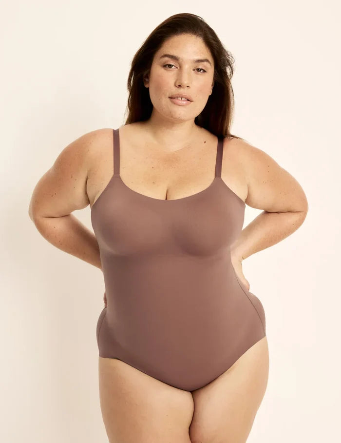 Clementine is a 40G, has 51" hips, is 5'9.5" tall and wears a size XXL++ | Front view of model wearing the Customizable Shaper Bodysuit highlighting the coverage and smooth fit | Sola