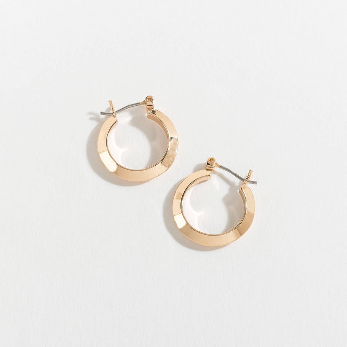 Gold hoop earrings on a light gray background