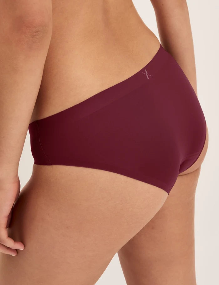 | Back view of model wearing the Essential No-Show Bikini highlighting the coverage and smooth fit | Pink Multi