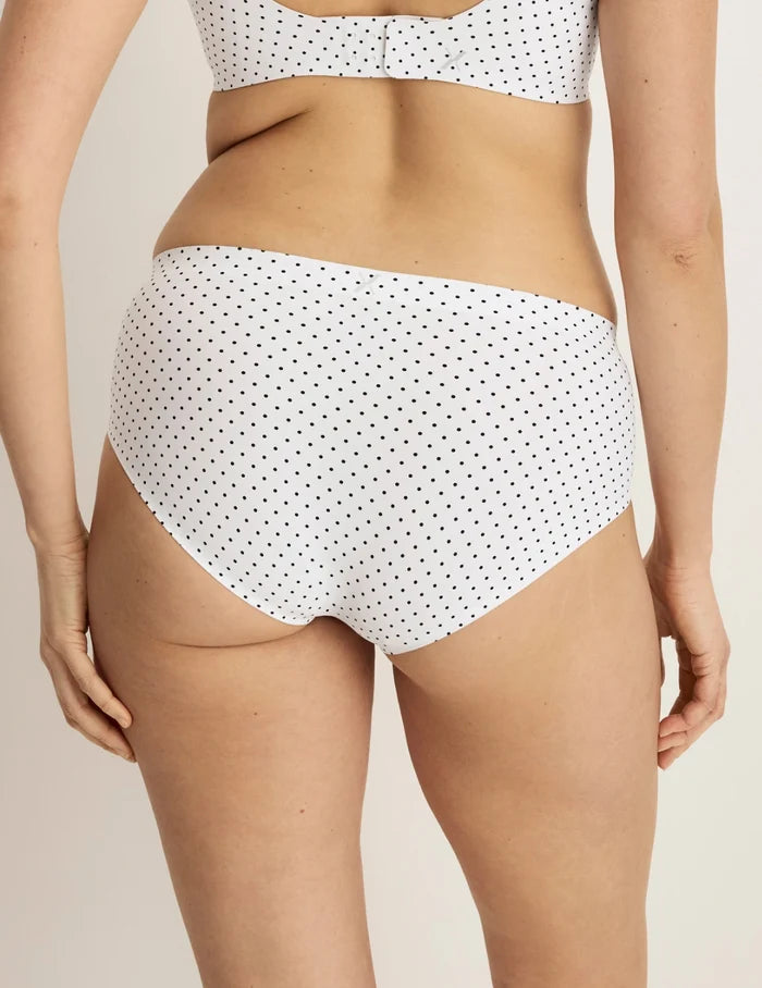 | Back view of model wearing the Essential No-Show Boyshort highlighting the coverage and smooth fit | White with Black Polka Dot