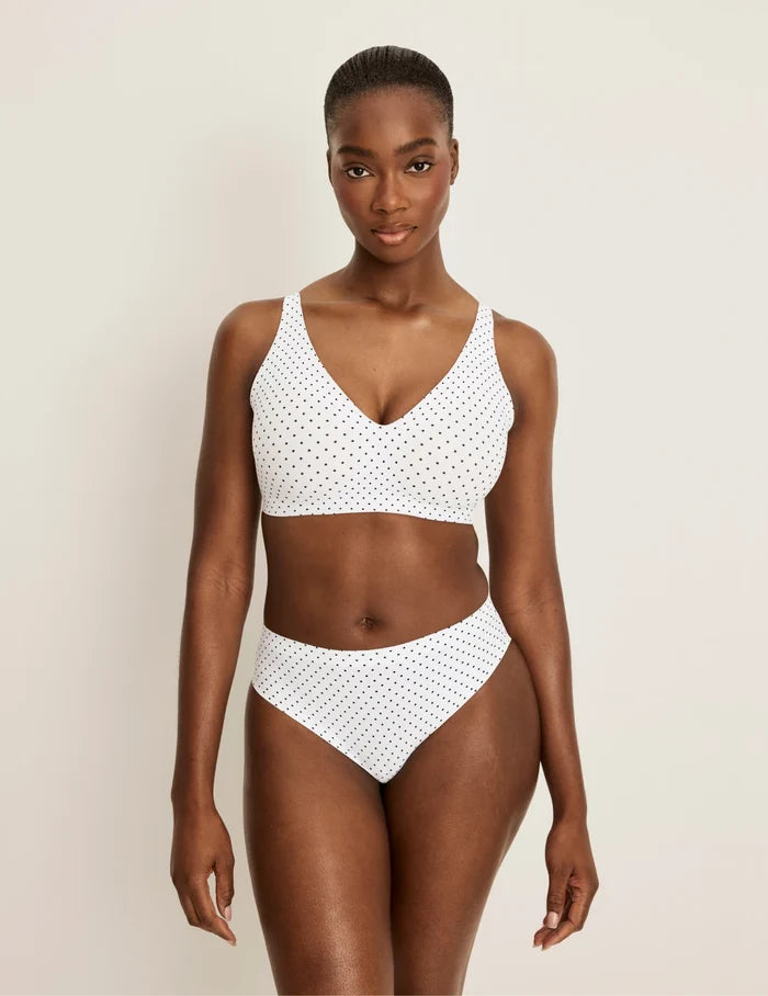 | Full-body view of model wearing the Essential No-Show French Cut highlighting the coverage and smooth fit | White with Black Polka Dot