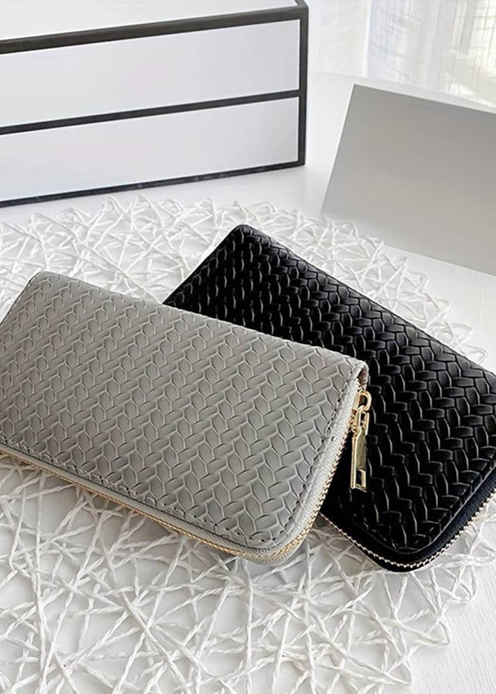 faux leather woven wallet.  can hold credit cards and cash and a few other items in the zippered area.