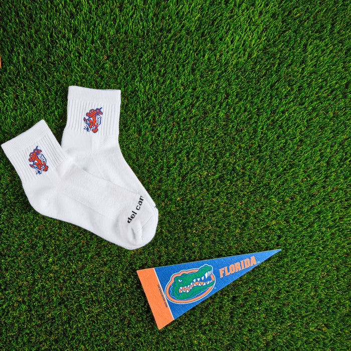 Del Campo Florida Gators Swinging Gator golf socks on turf with a team pennant