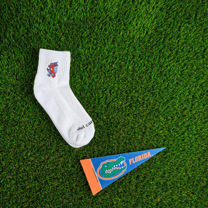 Flat lay of Del Campo Florida Gators Swinging Gator golf socks with game-day props