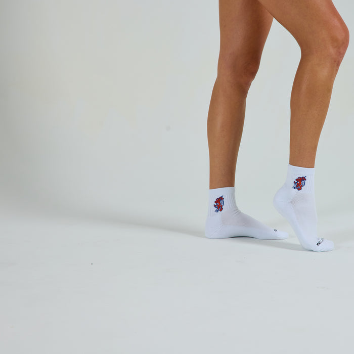 Woman wearing Del Campo Florida Gators Swinging Gator golf socks, studio shot, no shoes