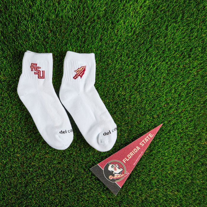Flat lay of Del Campo Florida State Pack golf socks with game-day props