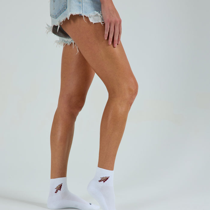 Woman wearing Del Campo Florida State Spear golf socks, studio shot, no shoes