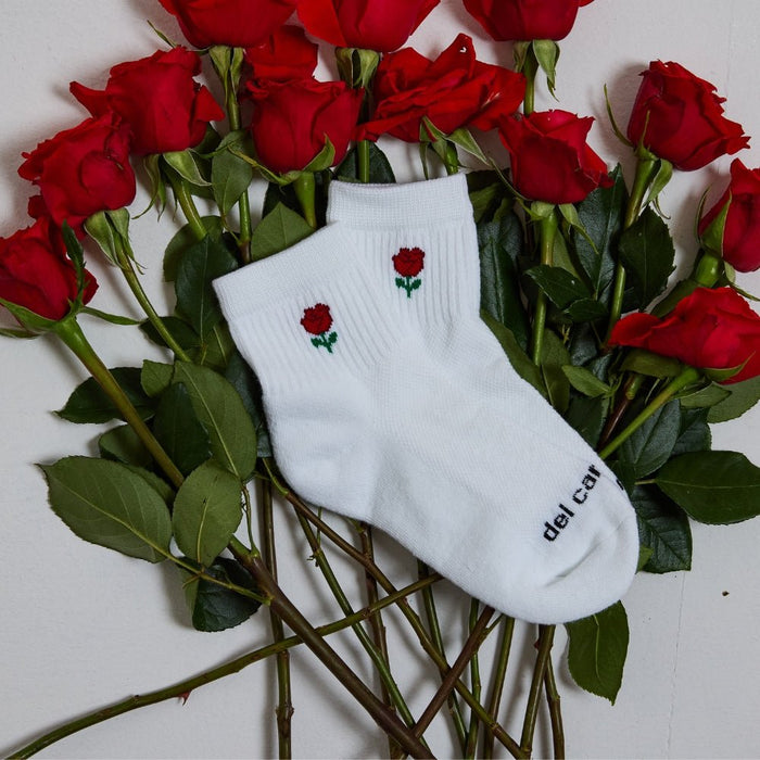 Del Campo Flower Pack golf socks featuring four floral designs: rose, sunflower, violet, and pink tulip