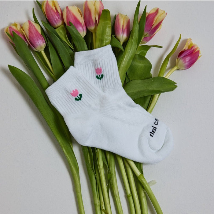 Del Campo Flower Pack golf socks featuring four floral designs: rose, sunflower, violet, and pink tulip
