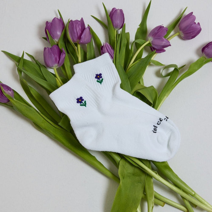 Del Campo Flower Pack golf socks featuring four floral designs: rose, sunflower, violet, and pink tulip