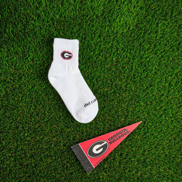 Flat lay of Del Campo Georgia Bulldogs golf socks with game-day props