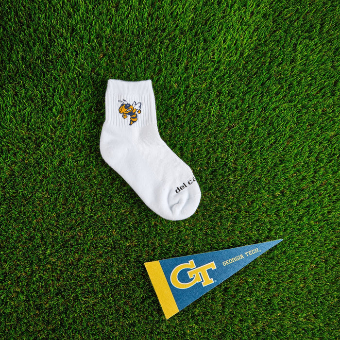 Flat lay of Del Campo Georgia Tech Buzz golf socks with game-day props