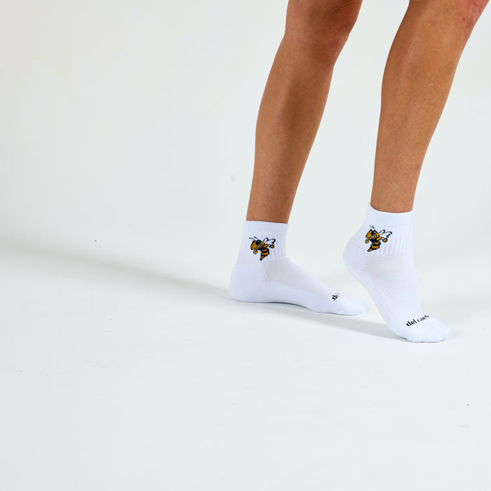 Woman wearing Del Campo Georgia Tech Buzz golf socks, studio shot, no shoes