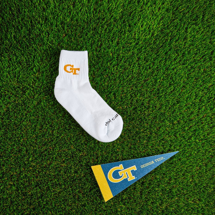 Flat lay of Del Campo Georgia Tech GT golf socks with game-day props