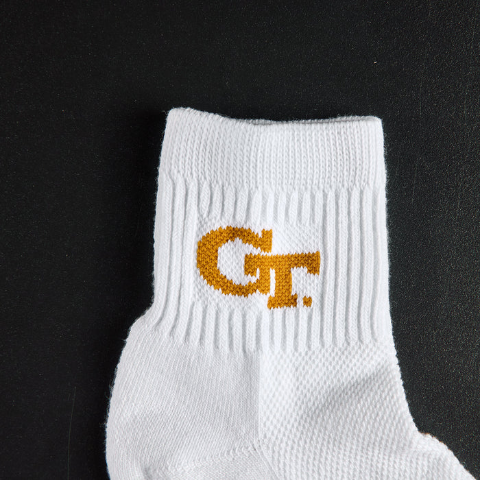Close-up of the old gold GT interlock wordmark on Del Campo Georgia Tech GT golf socks