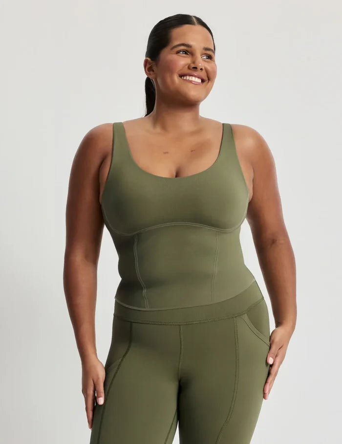 Adiya is a 36C and wears a Knix size L | Front view of model wearing the HiTouch™️ Active Contour Tank, highlighting the neckline, strap design, and silhouette | Olive