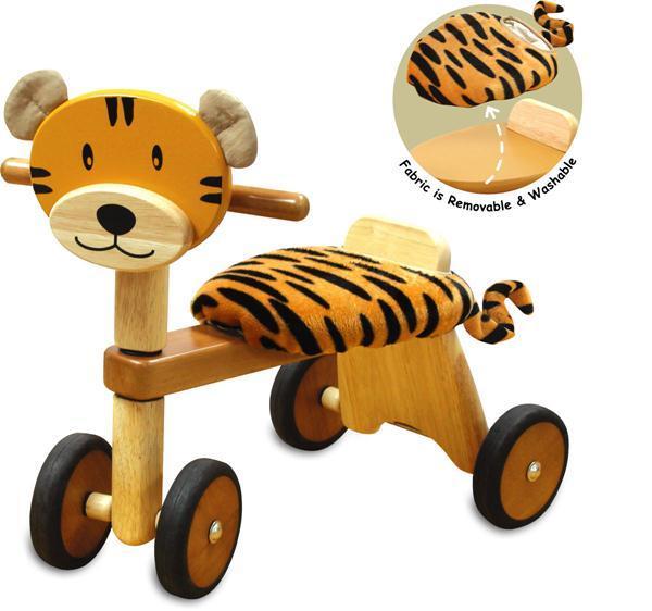 Toddler riding the I'm Toy Paddie Rider Tiger wooden ride-on tiger