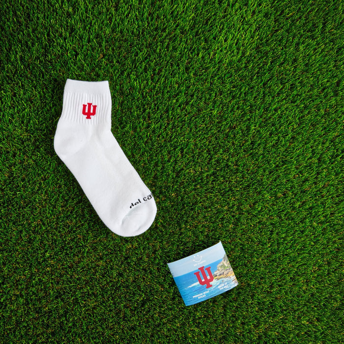 Flat lay of Del Campo Indiana Hoosiers golf socks with game-day props