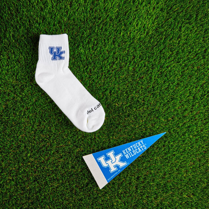 Flat lay of Del Campo Kentucky Wildcats golf socks with game-day props